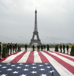 Student officers display a US giant national flag on the Trocadero square with the Eiffel tower in the background during a solemn tribute to the victims of the 9/11 attacks on September 11, 2011 in Paris. Several commemorations are held in France today to mark the 10th anniversary of the 9/11 attacks which killed almost 3,000 people in NYC and Washington and plunged the US into an era of war. AFP PHOTO / FRED DUFOUR (Photo credit should read FRED DUFOUR/AFP/Getty Images)